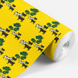 roll of yellow wallpaper with black and white cows standing around some green parsley 