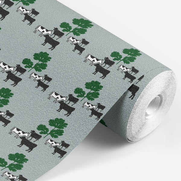 roll of Grey wallpaper with black and white cows standing around some green parsley 