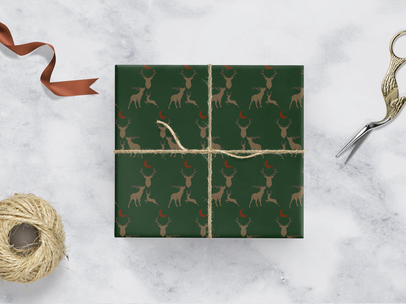 green Wrapping paper with 3 brown stags and a red moon 