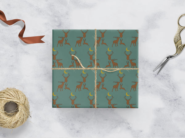 green Wrapping paper with 3 brown stags and a yellow moon 