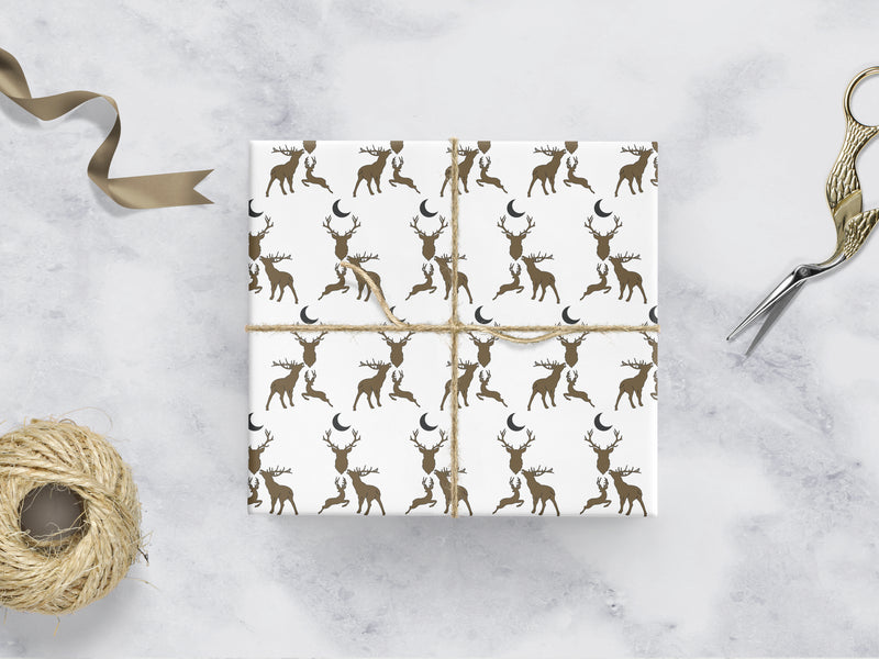 white Wrapping paper with 3 brown stags and a dark grey moon 