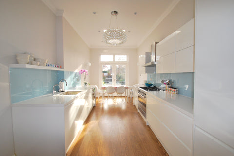 Galley kitchen blue splashback and white kitchen