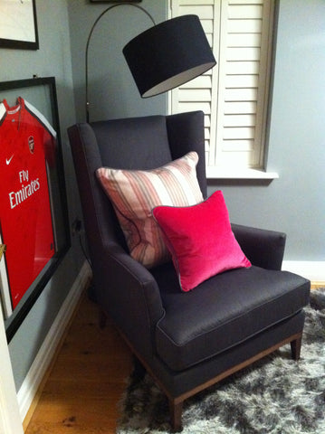 office with treasured items framed, comfy chair and punchy pink cushions